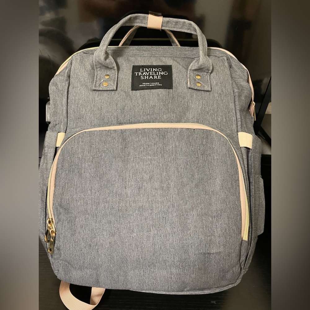 Living traveling share diaper backpack. In gray, lightly used! Like new!!
